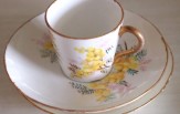 Jenni-Moore-cup-and-saucer Small bone china tea cup with gold rim and yellow flower pattern on cup and saucer