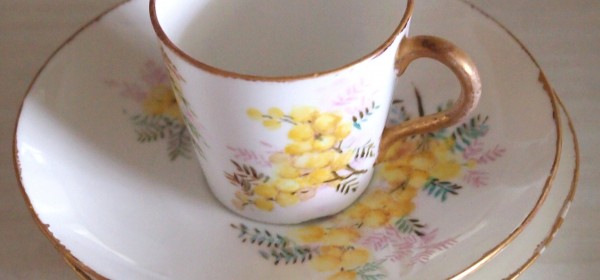 Jenni-Moore-cup-and-saucer Small bone china tea cup with gold rim and yellow flower pattern on cup and saucer