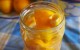 quartered lemons emersed in white vinegar in a jar