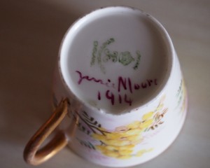 Bottom of tea cup, Crown imprint, painted on words: Jenni Moore 1914