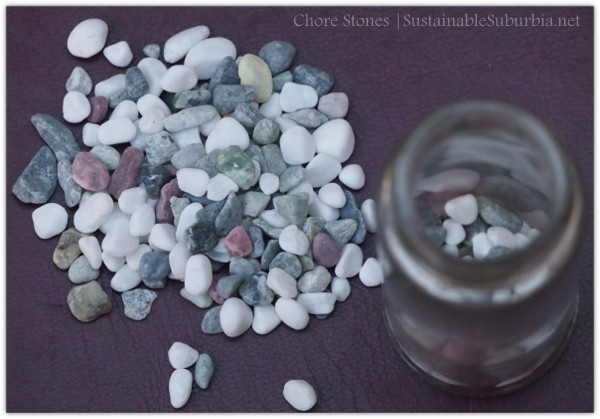 a small pile of pebbles next to a jar