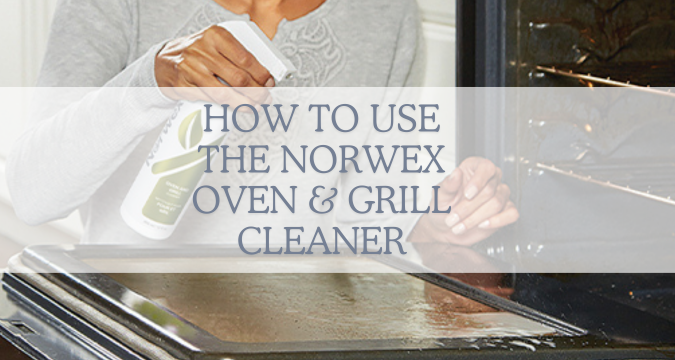 How to use the Norwex Oven & Grill Cleaner. image shows an open oven door, with hand holding a bottle of Norwex oven and grill cleaning and spraying the door.