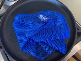 image of blue Norwex dishcloth on cast iron pan.